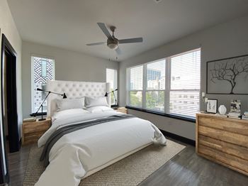 a bedroom with a large bed and a ceiling fan